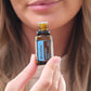 Woman holding a bottle labeled 'Breathe' close to her face