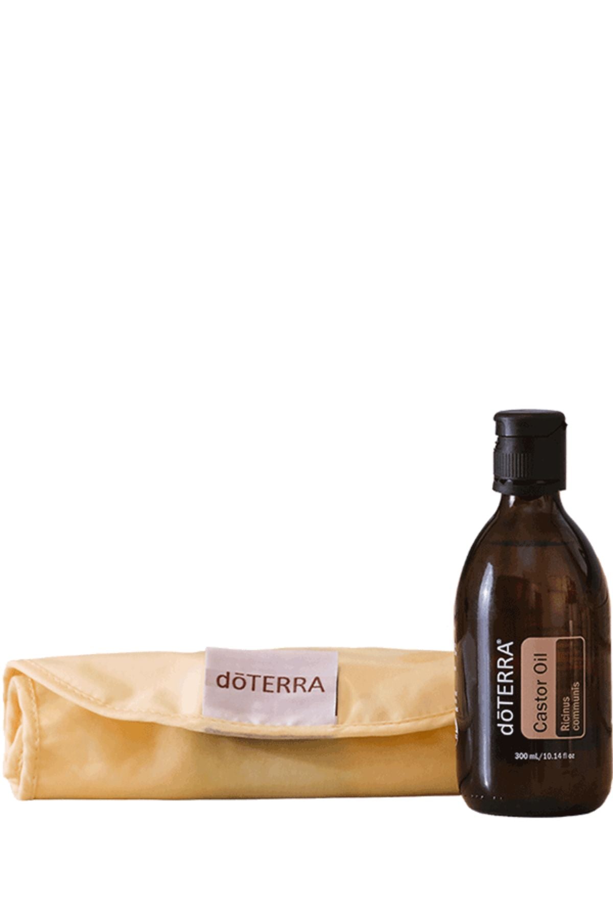 A bottle of doTERRA Castor Oil next to a folded beige doTERRA microfiber cloth on a plain white background.