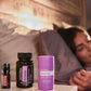 A person sleeping in bed in a warm bedroom setting, with three doTERRA Serenity products in the foreground on a bedside table: a small dark bottle, a black bottle, and a purple container. doTERRA Serenity Sleep System
