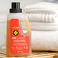doTERRA onGuard laundry detergent bottle with towels in the background